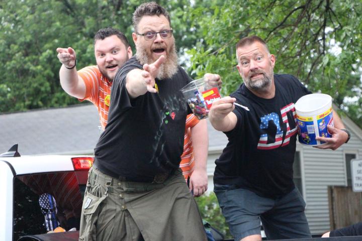 Dew Days co-chairs Jake Cordes and John Guist, along with Farmington Mayor Todd Larson, throw candy during the Dew Days grand parade. The parade, held Saturday, attracted plenty of onlookers despite the damp weather.