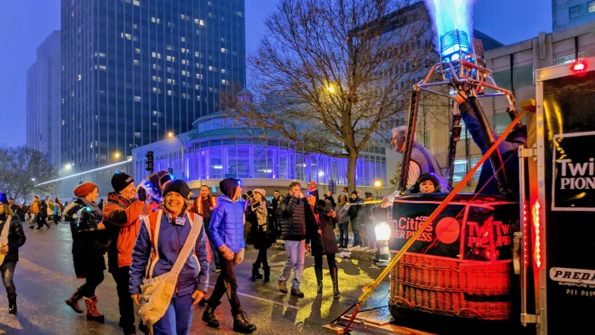 Pioneer Press Treasure Hunt winner John Collins, right, presides from a hot-air balloon gondola at the St. Paul Winter Carnival's Vulcan Victory Torchlight Parade on Saturday, Feb. 2, 2019. Collins' nephew, Carter, stands next to his uncle, as a propane flame shoots out above them. (Julio Ojeda-Zapata / Pioneer Press)