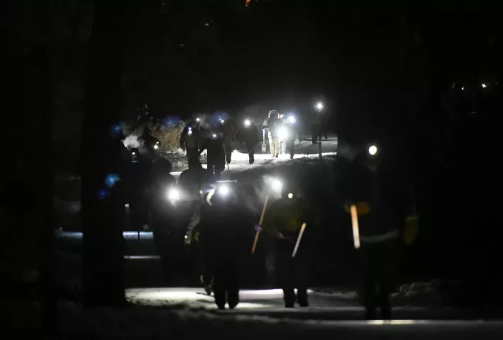 Treasure hunters stream out of the woods after word got around that the medallion had been found Wednesday January 30, 2019. (Special to the Pioneer Press: Craig Lassig)