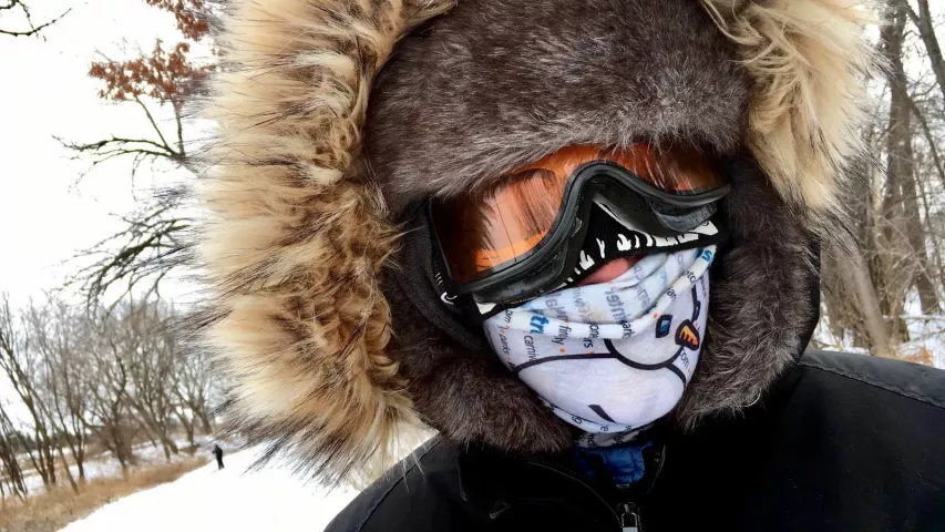 Mary Mulholland of Mounds View wears a skeleton mask over her forehead and under her goggles, an ear-flap hat and a Pioneer Press neck guard, all under her parka hood for the Pioneer Press Treasure Hunt on Tuesday, Jan. 29, 2019, at Long Lake Regional Park in New Brighton. She also stashed chemical hot packs above and below her feet. (Lisa Legge / Pioneer Press)