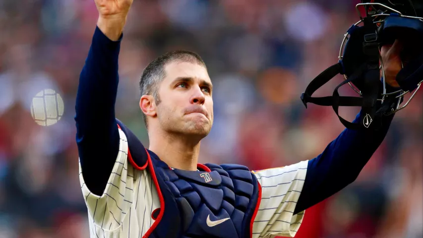 Joe Mauer acknowledges a standing ovation as he donned catcher’s gear and caught for one pitch against a Chicago White Sox batter in the ninth inning of a home game on Sept. 30, 2018. Mauer began his career as a catcher before switching to first base. (Jim Mone / Associated Press)