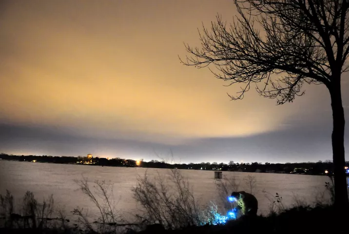 A Winter Carnival treasure hunter scours the shoreline at Tony Schmidt Park in Arden Hills for the medallion around 1 a.m. on Jan. 31, 2011. (Ben Garvin / Pioneer Press archives)