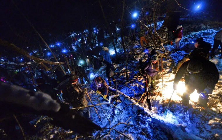 Hundreds of Pioneer Press Treasure Hunters dig and sift the snow around a large overturned tree as they search for the Pioneer Press Treasure Hunt medallion at Bald Eagle-Otter Lake Regional Park late Wednesday, Feb. 3, 2016. (John Autey / Pioneer Press)