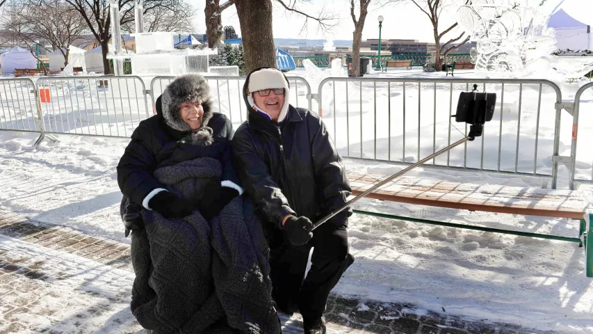 Steve and Carol Cermak of Bloomington use a selfie stick to photograph themselves with the St. Paul Winter Carnival ice sculptures in Kellogg Mall Park in below-zero temperatures Tuesday, Jan. 29, 2019. “Disability doesn’t stop us from getting out and sightseeing winter-spring-summer-fall,” said Steve Cermak. (Scott Takushi / Pioneer Press)