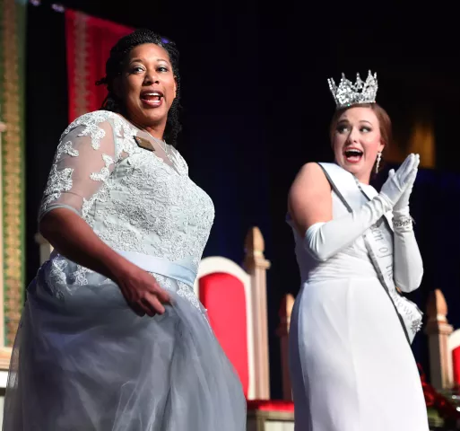Megan Quiggle, left, chosen as the 2019 Prime Minister of the Saint Paul Winter Carnival, dances as Alison Gunter, chosen to be Aurora, Queen of the Snows, looks on during Royal Coronation events at Saint Paul RiverCentre, Jan. 25, 2019. Quiggle is a teacher who is also a mom of seven, three of them are formerly Haitian orphans. The Royal Coronation is a 130+ year old Winter Carnival tradition. (Scott Takushi / Pioneer Press)