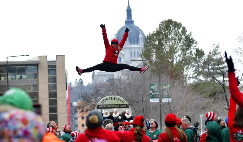 A St. Paul Bouncing Girl flies into the air during the 2020 St. Paul Winter Carnival King Boreas Grand Day Parade in downtown St. Paul on Saturday, Jan. 25, 2020. (John Autey / Pioneer Press)