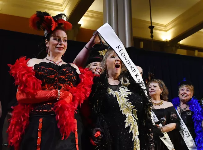 Sheryl Williams is sashed as the 2019 Klondike Kate by the 2018 Klondike Kate: Natalia Hemingway during a contest at the at the Landmark Center in St. Paul on Wednesday, Jan. 9, 2018. Williams, from Welch Township, is a wordsmith by day and a blackjack dealer by night. (John Autey / Pioneer Press)