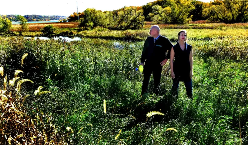 Mike Hahm, St. Paul Parks and Recreation Director, and Angie Tillges, from Great River Passage Initiative walk through Pig’s Eye Regional Park in St. Paul Thursday, Oct. 19, 2017. In the background is Pig’s Eye Lake, top left, and Battle Creek, behind them. (Jean Pieri / Pioneer Press)