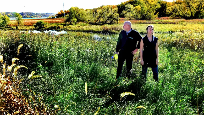 Mike Hahm, St. Paul Parks and Recreation Director, and Angie Tillges, from Great River Passage Initiative walk through Pig’s Eye Regional Park in St. Paul Thursday, Oct. 19, 2017. In the background is Pig’s Eye Lake, top left, and Battle Creek, behind them. (Jean Pieri / Pioneer Press)