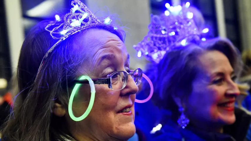 Senior Royalty Linda Jones wears earrings on her glasses at the St. Paul Winter Carnival Moon Glow Pedestrian Parade in St. Paul on Thursday, Jan. 25, 2018. With luminaries in hand to light the way, carnival dignitaries, ambassadors and organizers walk with local business leaders from the Securian Building on Sixth and Robert to Rice Park. (Jean Pieri / Pioneer Press)