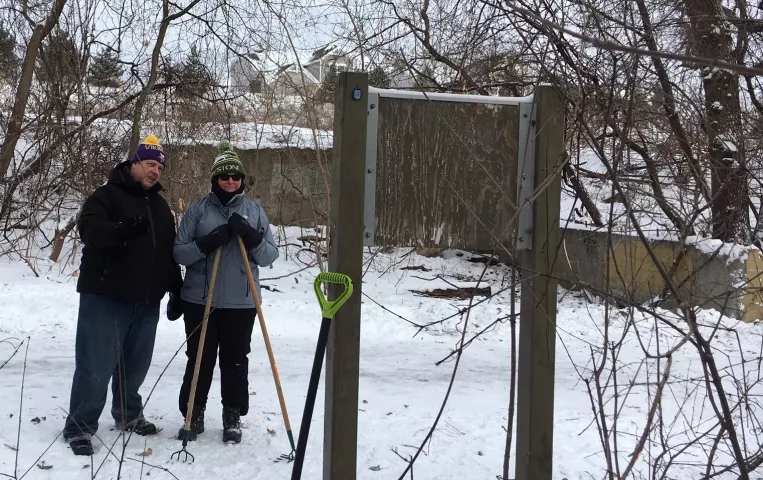 Pioneer Press Treasure Hunters Charlie Petron, of Maplewood, and Jennifer Millisor, of Cincinnati, reread a signpost about history at Long Lake Regional Park in New Brighton on Monday, Jan. 28, 2019. Petron's wife isn't as enthusiastic about the hunt — "only when she's out here, Petron said — so he persuaded their college friend Millisor to come to Minnesota in January for the hunt. "We love solving things," they both said. (Lisa Legge / Pioneer Press)