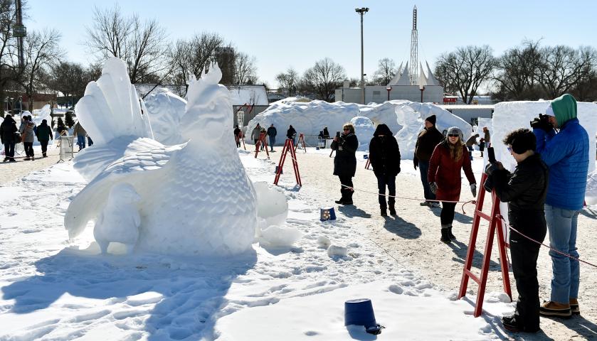 People admire the Eggloo snow sculpture at the Vulcan Snow Park at the Minnesota State Fair in Falcon Heights on Sunday, Feb, 11, 2018. Sunday was the last day of the St. Paul Winter Carnival. (John Autey / Pioneer Press)