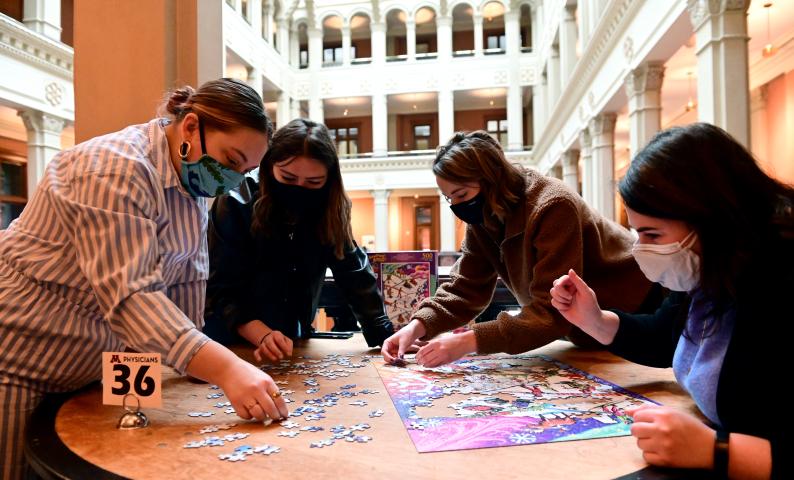 Work friends, from left, Whitney Storvick, Emma Koehn, Emilee Sirek and Victoria Speake put together a puzzle during the St. Paul Winter Carnival Puzzle Contest at the Landmark Center in downtown St. Paul on Saturday, Jan., 30, 2021. Sponsored by PuzzleTwist, roughly 150 teams in four categories competed to complete puzzles in the fastest time. (John Autey / Pioneer Press)