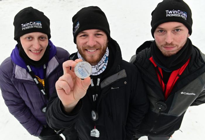 St. Paul Pioneer Press Treasure Hunt Medallion finders (from left) Julie Schonhardt, Josh Ellingson and Zak Rexford pose with their find at West Park in White Bear Lake on Sunday, Jan. 31, 2021. It was the second year that their team found the medallion. (John Autey / Pioneer Press)