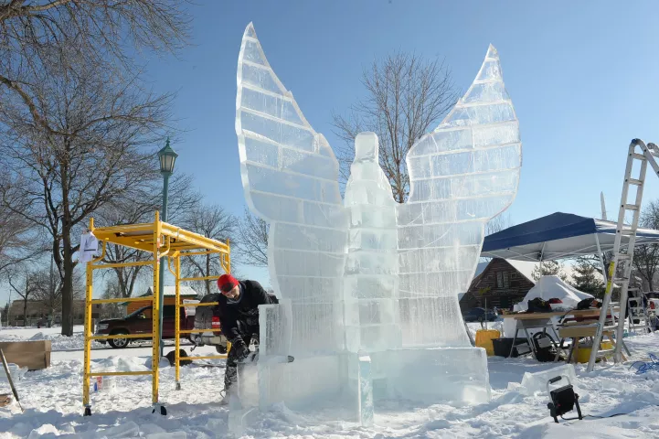 John Njoes of Minneapolis carves a phoenix out of ice at the Minnesota State Fairgrounds in Falcon Heights, Sunday, Jan. 24, 2021. Entitled "Phoenix Rising", his 12-foot tall creation will have a heap of rubble and the figure "2020" at its feet. This year's St. Paul Winter Carnival event is not a competition as in other years, due to it being a paid drive-through event open to paying vehicles only, each day from January 28th February 7th. (Scott Takushi / Pioneer Press)