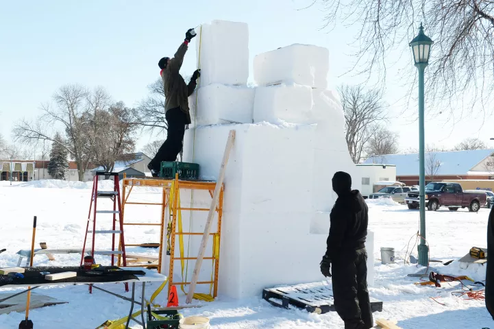 Kevin Wynn measures the heighto his team's 13-foot tall snow sculpturat the Minnesota State Fairgrounds in Falcon Heights, Sunday, Jan. 24, 2021. Entitled "Redemption", the Star Wars themed creation features the Mandalorian and the robot IG-11. The Pigs Eye Pirates team of Jason and Shelden Moe and Wynn created last year's Baby Yoda, which won the carnival's People's Choice award and received nationwide media attention. This year's St. Paul Winter Carnival event is not a competition as in other years, due t