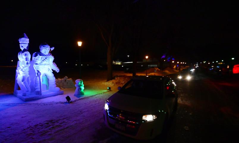 Cars make their way past a sculpture of The Mandalorian and Baby Yoda at the St. Paul Winter Carnival Drive-Thru Ice and Snow Sculpture Park on the Minnesota State Fairgrounds in Falcon Heights on Thursday, Jan. 28, 2021. (John Autey / Pioneer Press)