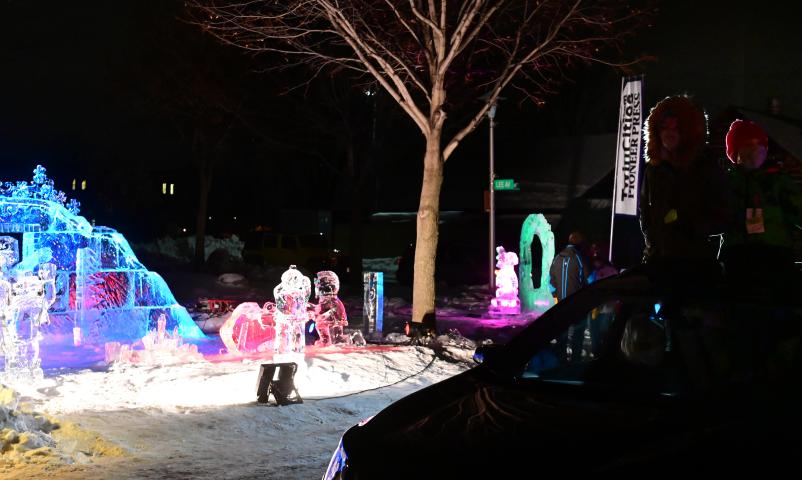 Kaia, left, and Alton Smith of Mendota Heights take in the sighs from the the sunroof of the family car at the St. Paul Winter Carnival Drive-Thru Ice and Snow Sculpture Park on the Minnesota State Fairgrounds in Falcon Heights on Thursday, Jan. 28, 2021. (John Autey / Pioneer Press)