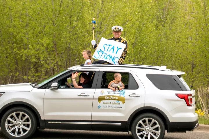 Darrin Johnson, the 2020-21 King Boreas of the St. Paul Winter Carnival, with his wife, driver Emily Gerbig, and their kids, daughter Sydney Johnson and son Theodore Johnson, during a drive-by parade in Maplewood on May 17, 2020. (Lew Ferty Vogel / St. Paul Winter Carnival)