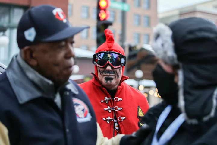 As Tony Oliva, Grand Marshall of the Vulcan Victory Torchlight Parade, speaks with people after being knighted, the Vulcans look on Saturday, Feb. 5, 2022. ((Hannah Hobus / Pioneer Press)