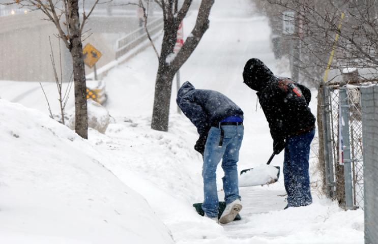 Jose Perez (right) and his son Jose Perez (cq) shoveled the sidewalk in front of their Robert St. home in St. Paul, as a major snowstorm hit the Twin Cities on Sunday, Feb. 20, 2011. (Pioneer Press: Scott Takushi)