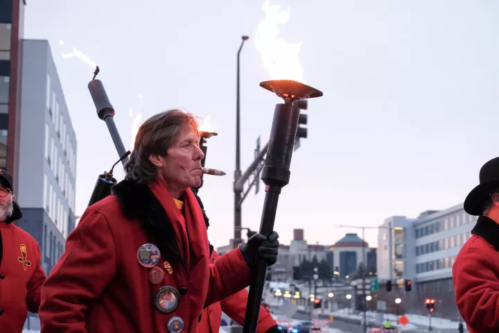 St. Paul community members march in the Torchlight parade during the winter carnival in downtown St. Paul on Feb. 4, 2023. The torchlight parade symbolizes Vulcanus Rex’s march on the ice castle to take the throne from King Boreas, a legend made into tradition every year at St. Paul’s winter carnival. (Bryson Rossell / Pioneer Press)