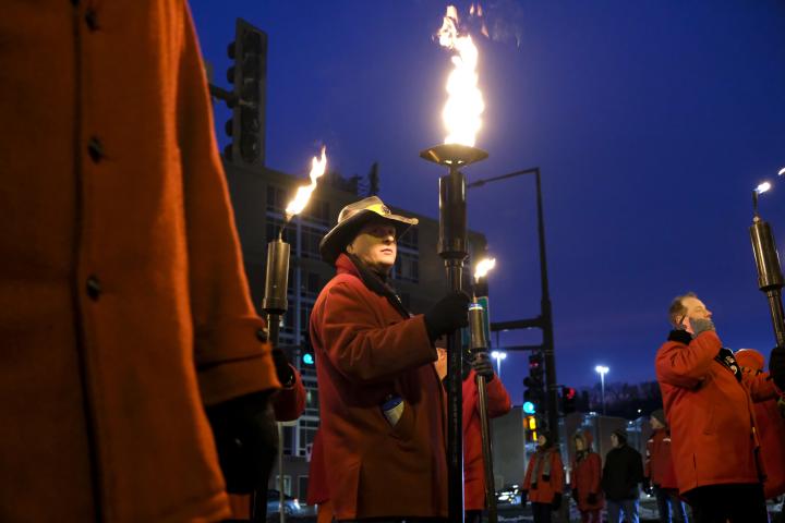 St. Paul community members march in the Torchlight parade during the winter carnival in downtown St. Paul on Feb. 4, 2023. The torchlight parade symbolizes Vulcanus Rex’s march on the ice castle to take the throne from King Boreas, a legend made into tradition every year at St. Paul’s winter carnival. (Bryson Rossell / Pioneer Press)