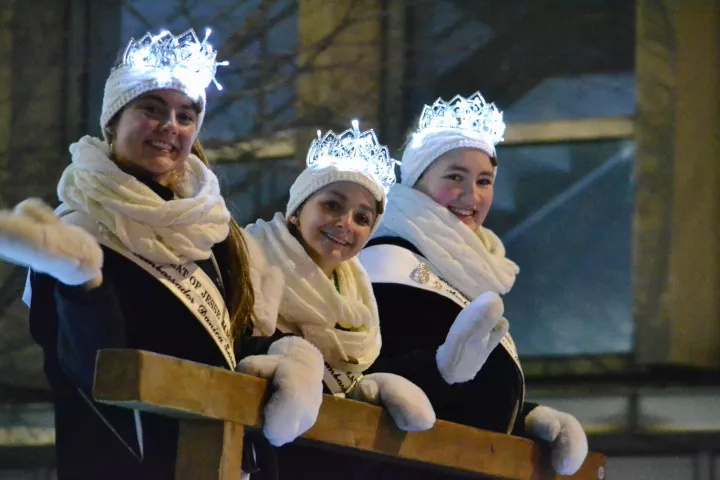Parade royalty wave at paradegoers during the Vulcan Victory Torchlight Parade on Saturday, Feb. 3, 2024. The parade is part of St. Paul's Winter Carnival. (Gabrielle Erenstein / Pioneer Press).