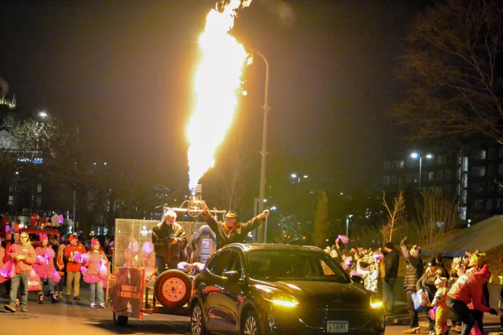 A hot air balloon burner shoots fire into the air in downtown St. Paul during the Vulcan Victory Torchlight Parade on Saturday, Feb. 3, 2024. The parade hopes to bring summer back to the city of St. Paul. (Gabrielle Erenstein / Pioneer Press).