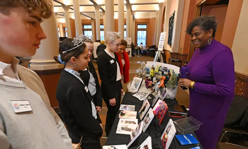 Robin Hickman-Winfield explains her family's connection to Rondo Avenue to Junior Royalty during the St. Paul Winter Carnival’s Rondo Night at the Landmark Center in downtown St. Paul on Thursday, Feb. 2, 2023. (John Autey / Pioneer Press)