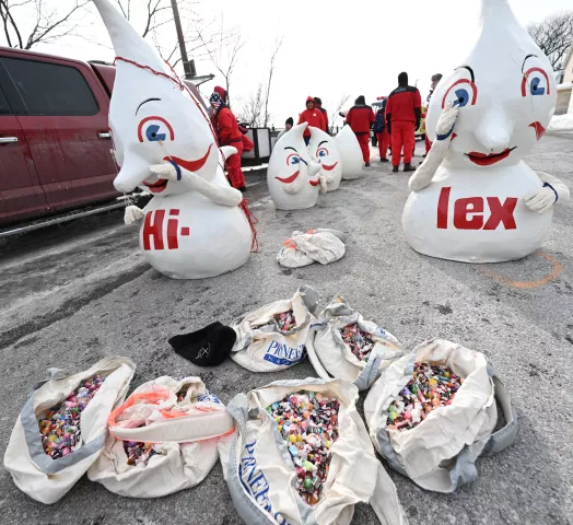 Alongside Pioneer Press newspaper carrier bags full of candy, the Hilex Gnomes wait for the start of the 2023 Winter Carnival Grande Day Parade in downtown St. Paul on Saturday, Jan. 28, 2023. (John Autey / Pioneer Press)