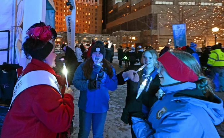 Ellie Bowen, center facing, 11, from White Bear Lake, Lyndsey Thron,, second from right, 18, from Mounds View, and Chloe Lunzer, right, 14, from Stillwater, sing with 2022 Klondike Kate Tina Hacker at Rice Park in St. Paul on Thursday, Jan. 26, 2023. The Royal Family and the Vulcans joined with community members to officially start the 2023 St. Paul Winter Carnival. (John Autey / Pioneer Press)