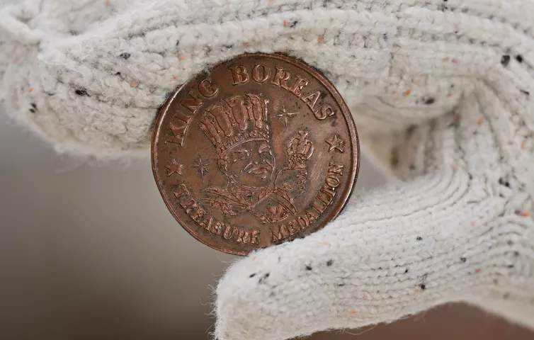 A model holds one of the original bronze medallions used for the St. Paul Pioneer Press Treasure Hunt in St. Paul on Thursday, Jan. 18, 2024. (John Autey / Pioneer Press)