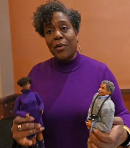 Robin Hickman-Winfield holds a doll of herself, left, and her great uncle Gordon Parks at her table during the St. Paul Winter Carnival’s Rondo Night at the Landmark Center in downtown St. Paul on Thursday, Feb. 2, 2023. (John Autey / Pioneer Press)