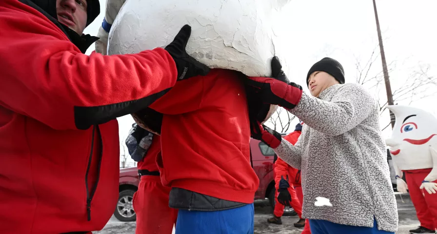 A Hilex Gnome marcher dons his costume before the start of the 2023 Winter Carnival Grande Day Parade in downtown St. Paul on Saturday, Jan. 28, 2023. (John Autey / Pioneer Press)