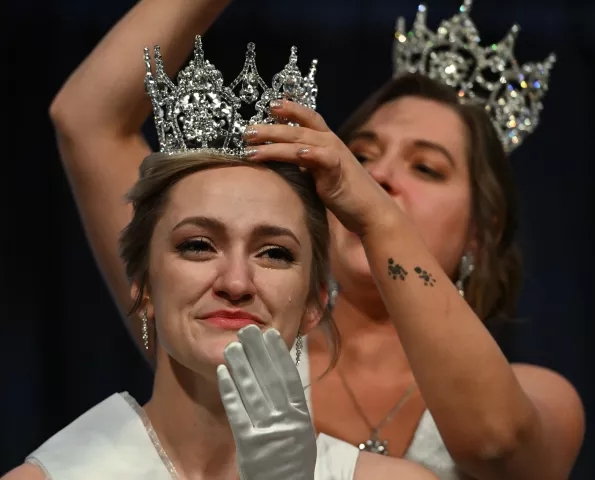 Liv Swenson wipes away a tear after being named 2023 Aurora, Queen of the Snows during the 2023 Winter Carnival Royal Coronation at St. Paul RiverCentre on Friday, Jan. 27, 2023. Crowning Swenson is 2022 Aurora Queen of the Snows Effie Barnes. (John Autey / Pioneer Press)