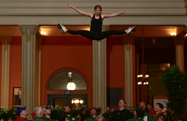 Lori Skarupa stretches out at the top of her bounce during the St. Paul Bouncing Team’s Bouncing Girl tryouts at the Landmark Center in St. Paul on Friday, Feb. 2, 2024. One of the oldest and most popular performers in the St. Paul Winter Carnival, the St. Paul Bouncing Team's chant of “One! Two! Up she goes!” can be heard around the Twin Cities as they perform aerial acrobatics throughout the year. (John Autey / Pioneer Press)