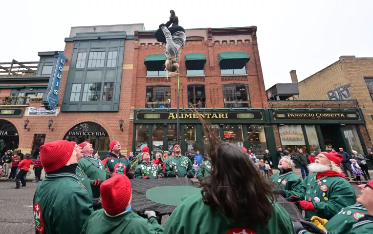 The St. Paul Bouncing Team flips a team member skyward during the 2024 St. Paul Winter Carnival King Boreas Grande Day Parade along West 7th Street in St. Paul on Saturday, Jan. 27, 2024. (John Autey / Pioneer Press)
