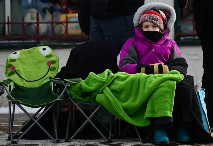 Morgan Glancy, 8, from Stillwater stays warm at the 2023 Winter Carnival Grande Day Parade in downtown St. Paul on Saturday, Jan. 28, 2023. (John Autey / Pioneer Press)