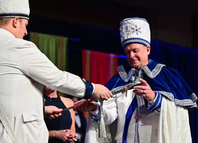 Eddy Wieger, Titan, Prince of the North Wind is handed his sword by outgoing Prince of the North Win, Dave Schmidt during the 2024 St. Paul Winter Carnival Royal Coronation at the RiverCentre in St. Paul on Friday, Jan. 26, 2024. (John Autey / Pioneer Press)