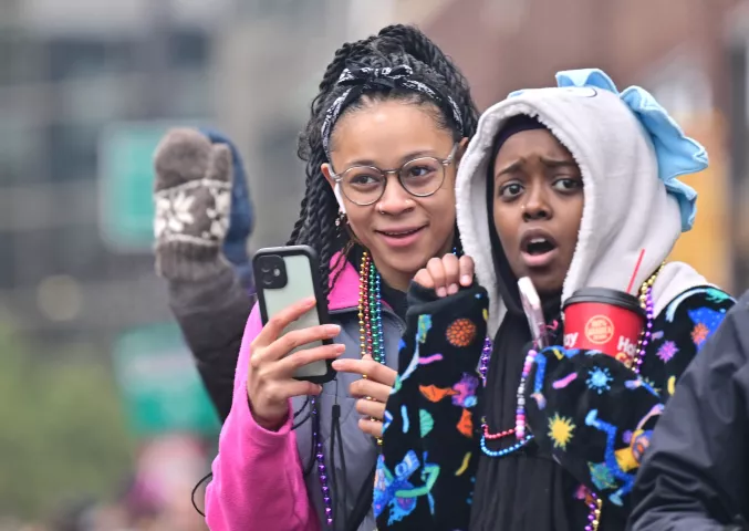 Maresa Schaurz, left and Faiza Ali watch 2024 St. Paul Winter Carnival King Boreas Grande Day Parade along West 7th Street in downtown on Saturday, Jan. 27, 2024. (John Autey / Pioneer Press)