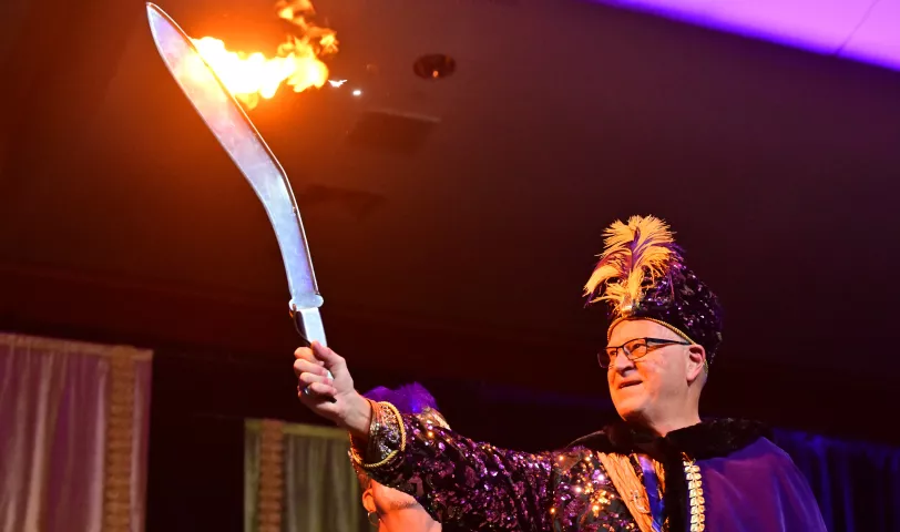 Ron Mikolai, 2024 Euros, Prince of the East Wind, holds his flaming sword during the 2024 St. Paul Winter Carnival Royal Coronation at the RiverCentre in St. Paul on Friday, Jan. 26, 2024. (John Autey / Pioneer Press)