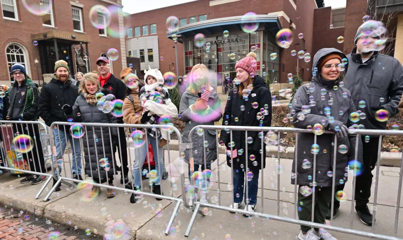 People watch during the 2024 St. Paul Winter Carnival King Boreas Grande Day Parade along Market Street in downtown from behind a wall of bubbles, complements of the the Shrine Circus clowns on Saturday, Jan. 27, 2024. (John Autey / Pioneer Press)