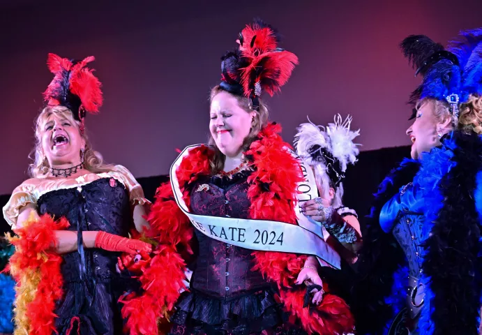 Jody Vander Hart, center, from Vadnais Heights, is sashed as 2024 Klondike Kate during the Klondike Kate Contest at the Mintahoe Catering &amp; Events - Inwood Oaks Event Center in Oakdale on Wednesday, Jan. 10, 2024. Cheering her on were fellow contestants Kira Sable from Minneapolis, left, and Kat Connery, from Robinsdale, right. Vander Hart joins previous Klondike Kates as members of the St. Paul Winter Carnival Royal Order of the Klondike Kates. (John Autey / Pioneer Press)