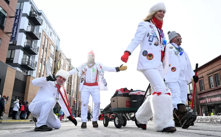 Members of the Tux Team Pooper Scoopers ham it up at the 2023 Winter Carnival Grande Day Parade in downtown St. Paul on Saturday, Jan. 28, 2023. (John Autey / Pioneer Press)