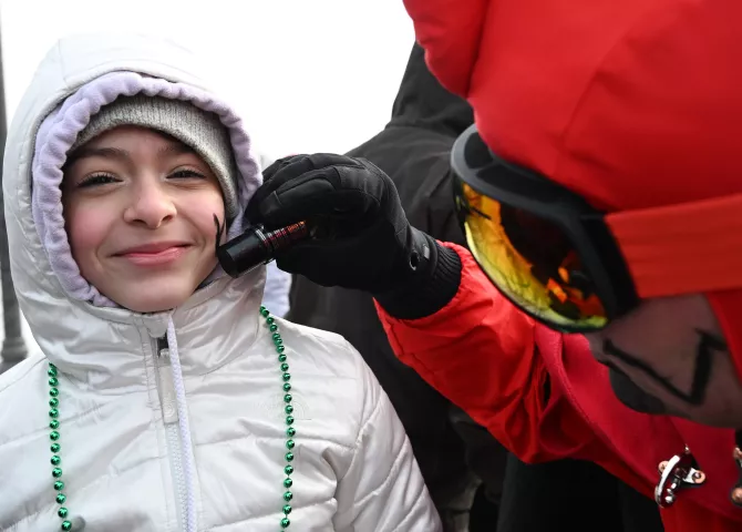 Elly Johnson, 12, from Lakeville gets a Vulcan V at the 2023 Winter Carnival Grande Day Parade in downtown St. Paul on Saturday, Jan. 28, 2023. (John Autey / Pioneer Press)