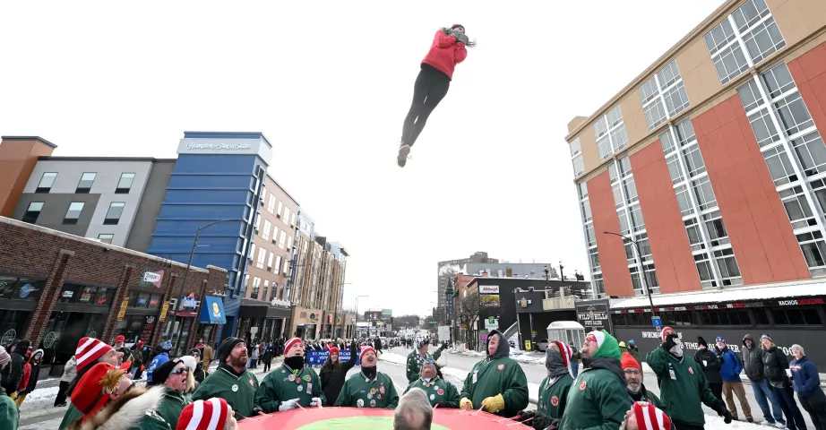 A bouncing girl with the St. Paul Bouncing Team rockets into the air during the 2023 Winter Carnival Grande Day Parade in downtown St. Paul on Saturday, Jan. 28, 2023. (John Autey / Pioneer Press)