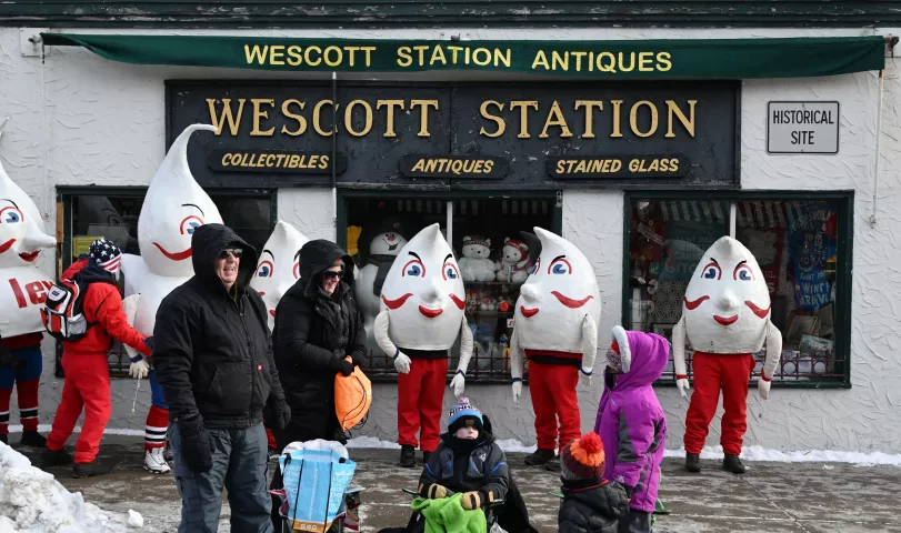 The Hilex Gnomes rest against the Wescott Station Antiques store after marching in the 2023 Winter Carnival Grande Day Parade in downtown St. Paul on Saturday, Jan. 28, 2023. (John Autey / Pioneer Press)